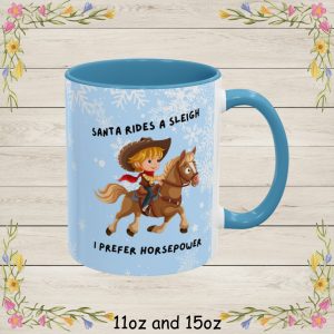 This adorable cartoon illustration reads Santa Rides A Sleigh, I Prefer Horsepower and features a cheerful young cowboy riding a galloping horse, complete with a wide-brimmed hat, red bandana, and classic western outfit.